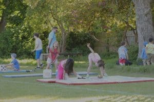 Children practicing yoga outdoors at Inchmarlo, enjoying nature and promoting wellness.