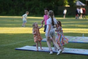Children playing on grassy outdoor area at Inchmarlo estate, family fun in a scenic Scottish location.