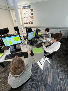 Students working on computers in a classroom, technology and learning environment at Inchmarlo.