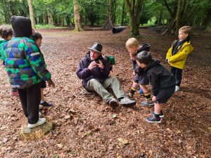 Outdoor learning activities for children at Inchmarlo in a lush forest setting.