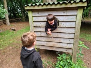 Children playing outdoors at Inchmarlo estate in a woodland setting.