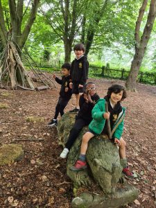 Group of children exploring woodland at Inchmarlo, enjoying nature and outdoor activities.