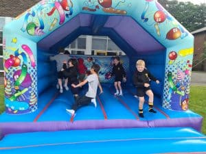 Bright inflatable bounce house at Inchmarlo, perfect for children's outdoor play and entertainment.