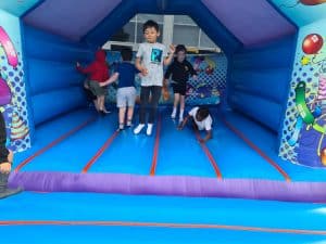 Children enjoying the inflatable bounce house at Inchmarlo. Perfect for family fun and outdoor activities.