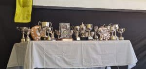 Table of silver trophies and awards at Inchmarlo event. Elegant display for ceremonies.