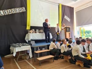 Engaging classroom scene at Inchmarlo School, showcasing students and teachers during a presentation.