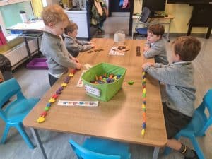Children playing with colorful building blocks at Inchmarlo childcare center.