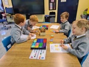 Children engaging in educational activities at Inchmarlo school classroom.