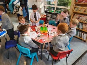 Children engaging in educational activities at Inchmarlo school classroom.