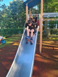 Children playing on a slide at Inchmarlo outdoor playground.