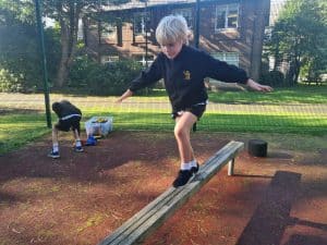 Children playing on outdoor play equipment at Inchmarlo, a scenic and family-friendly location.