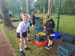 Children playing with outdoor toys at Inchmarlo school playground.