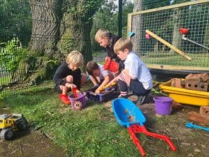 Children playing with outdoor toys at Inchmarlo outdoor play area.