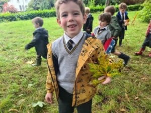 Children exploring outdoors at Inchmarlo, vibrant school environment in Scotland.