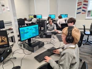 Students working on computers in a classroom setting.