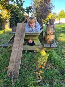 Child enjoying outdoor play at Inchmarlo estate with lush greenery.