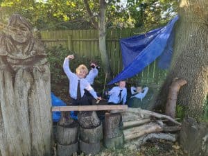 Outdoor children's play area with a treehouse and wooden structures at Inchmarlo.