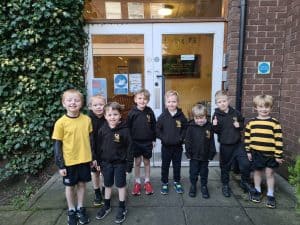 Children standing outside Inchmarlo main entrance, local school in Scotland.
