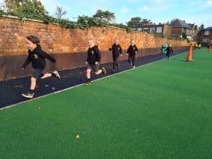 Children running on outdoor sports track at Inchmarlo.