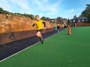 Child running on outdoor playground at Inchmarlo. Safe, vibrant recreational space for kids.