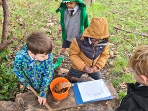Children exploring nature at Inchmarlo estate, engaging in outdoor educational activities.