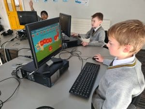 Students engaging with educational computer games at Inchmarlo School.