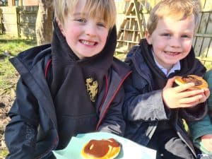 Two happy children enjoying outdoor snacks at Inchmarlo.