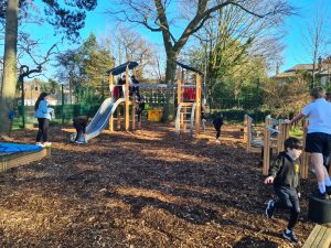 Children playing on outdoor residential playground at Inchmarlo estate.