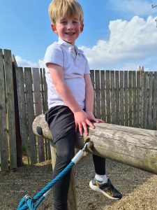Child enjoying outdoor play at Inchmarlo in Scotland, showcasing outdoor activities and family fun.