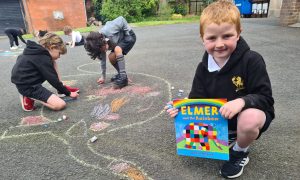 Children drawing with chalk on playground at Inchmarlo School.