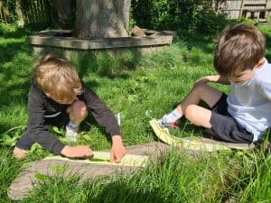 Children playing outdoors in a lush green garden at Inchmarlo.