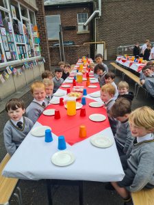 Children enjoying a festive meal outdoors at Inchmarlo school.