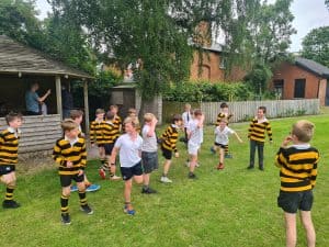 Children playing outside at Inchmarlo school in uniforms.