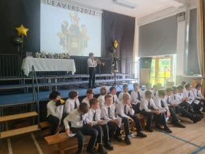 Students performing on stage at Inchmarlo School event.