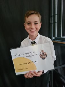 Young boy holding a certificate at Inchmarlo event.