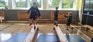 Children playing on balance beams at Inchmarlo pre-school.