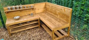 Wooden outdoor garden bench with storage, ideal for outdoor seating and relaxation.