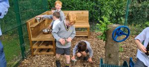Children playing and exploring in Inchmarlo outdoor space, emphasizing community and recreational activities.