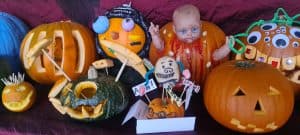 Colorful carved pumpkins and Halloween decorations for Inchmarlo festivities.