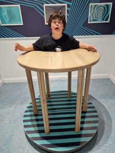 Child standing behind a round table at Inchmarlo estate.