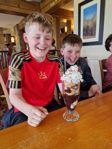 Smiling children enjoying ice cream at Inchmarlo family-friendly restaurant.