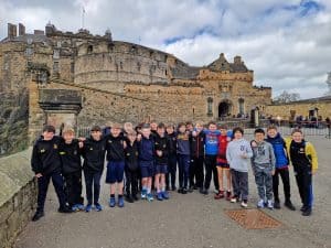 Group of students posing outside Inchmarlo estate in Scotland.