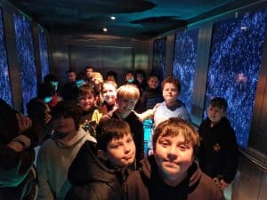 Children exploring digital planetarium at Inchmarlo for educational fun.