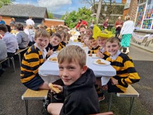 Children enjoying outdoor lunch at Inchmarlo, a scenic and educational outdoor space.