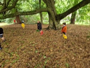Children playing under large tree at Inchmarlo outdoor play area.