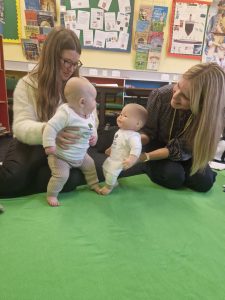 Two babies playing with adult supervision at Inchmarlo nursery.