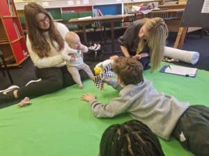 Children engaging in puppet play at Inchmarlo childcare center.