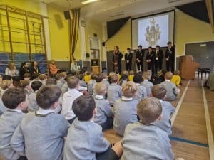 Students attending a classroom presentation at Inchmarlo School in a school hall.