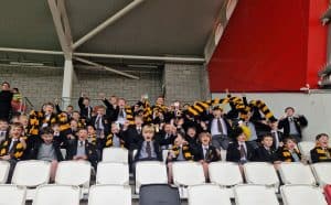 A lively group of golfers celebrating at Inchmarlo Golf Club, showcasing a vibrant and social golfing environment.