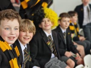 Students in school uniform, smiling at Inchmarlo School event.